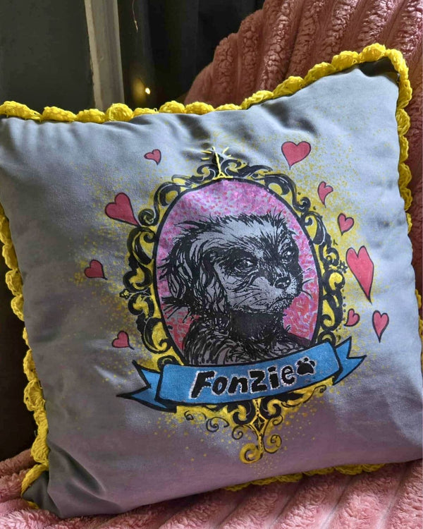 Silkscreened and hand-painted pillow with a design of a dog's face, hearts, and 'Fonzie' text on a yellow and gray background.